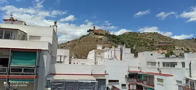 a group of buildings in front of a mountain at Saint Germain 2C in Cullera