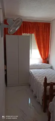 a bedroom with a white bed and a window at Saint Germain 2C in Cullera