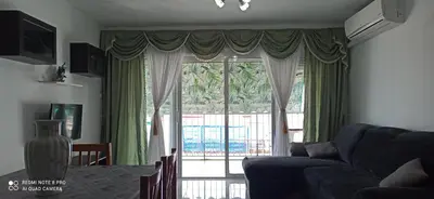 a living room with a couch and a large window at Saint Germain 2C in Cullera