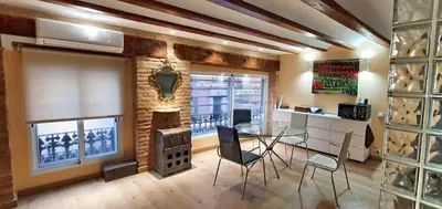 a dining room with a glass table and a fireplace at Lepanto Centro Valencia1 in Valencia