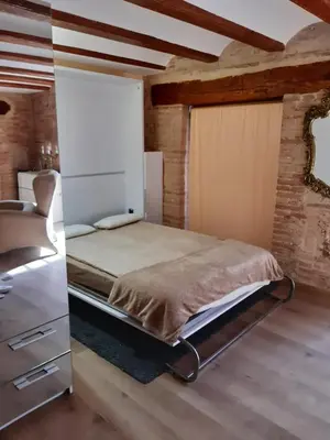 a bedroom with a bed and a brick wall at Lepanto Centro Valencia1 in Valencia
