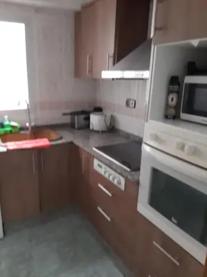 a kitchen with a stove and a microwave at habitación grande en piso compartido con 2 adultos in Valencia