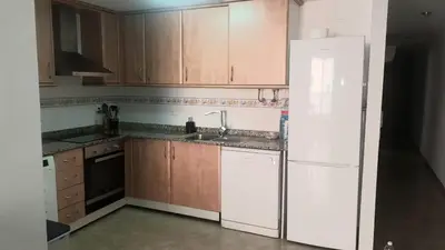 a kitchen with wooden cabinets and a white refrigerator at SUN&BEACH Moncofar in Moncófar