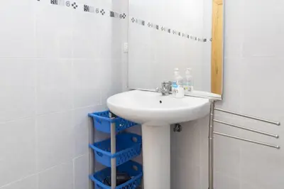a bathroom with a sink and a mirror at Solimar, 5-24 in Cullera