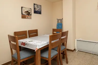 a dining room with a table and four chairs at Solimar, 5-24 in Cullera
