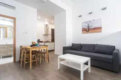 a living room with a couch and a table at Exclusivos Lofts en Plaza del Ayuntamiento in Valencia
