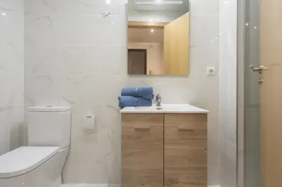 a bathroom with a toilet and a sink and a mirror at Exclusivos Lofts en Plaza del Ayuntamiento in Valencia