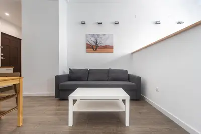 a living room with a couch and a table at Exclusivos Lofts en Plaza del Ayuntamiento in Valencia