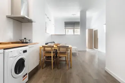 a kitchen with a table and a washing machine at Exclusivos Lofts en Plaza del Ayuntamiento in Valencia