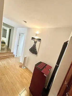 a room with a refrigerator and a picture on the wall at EL RINCÓN deMANUELA in Requena
