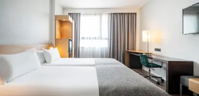 a hotel room with a bed and a desk at Ilunion Valencia 4 in Valencia