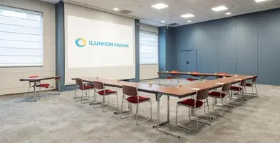 a gym with several treadmills and elliptical machines at Ilunion Valencia 4 in Valencia