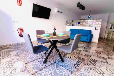 a living room with a table with chairs and a couch at Arenas beach in Valencia