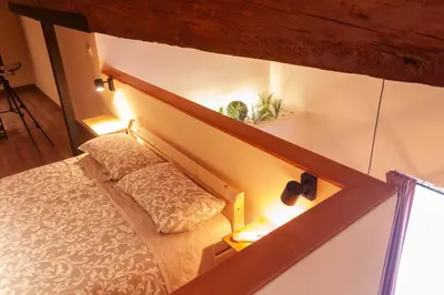 a room with a bed and a staircase with lights at Marittimo Apartments in Valencia