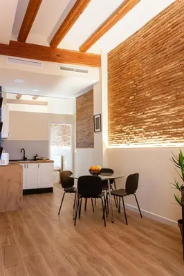 a kitchen and dining room with a table and chairs at Marittimo Apartments in Valencia