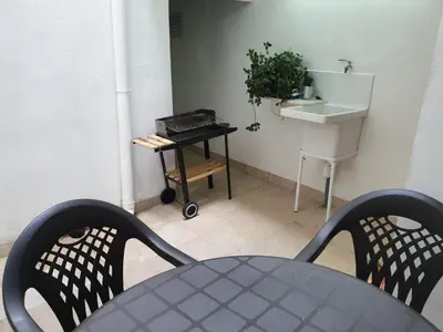 a table and two chairs in a room with a sink at Casa Castillo de la Estrella in Segorbe