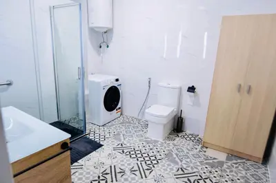 a bathroom with a toilet and a washing machine at Arenas beach 2 in Valencia