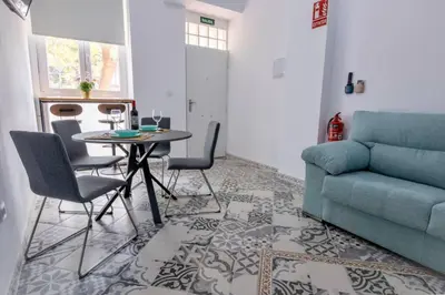 a living room with a table and a couch at Arenas beach 3 in Valencia