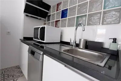 a kitchen with a sink and a microwave at Arenas beach 3 in Valencia