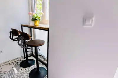 a stool in a room with a table and a window at Arenas beach 3 in Valencia