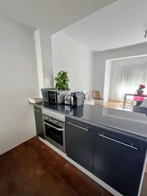 a kitchen with a counter top with a stove top oven at Aitana in Fortaleny