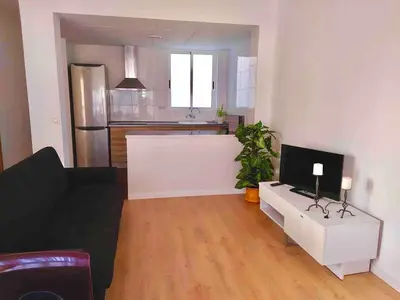 a living room with a couch and a table with a television at Aitana in Fortaleny