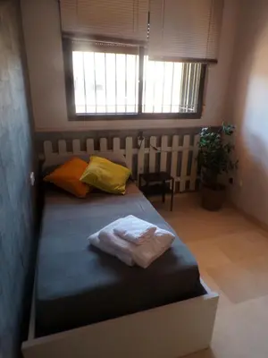 a bed with two towels on it in a bedroom at Casa MUNDOVALENCIA in Valencia