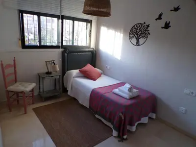 a bedroom with a bed and a table in it at Casa MUNDOVALENCIA in Valencia