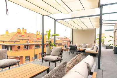 a patio with chairs and tables on a building at Valencia Luxury - Sea Port II in Valencia