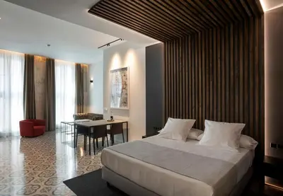 a bedroom with a large bed and a dining room at Fetén in Valencia