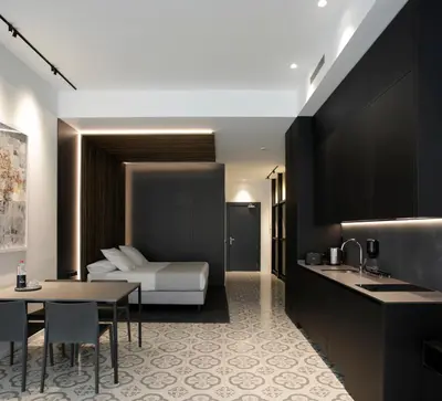 a hotel room with a bed and a table and a kitchen at Fetén in Valencia