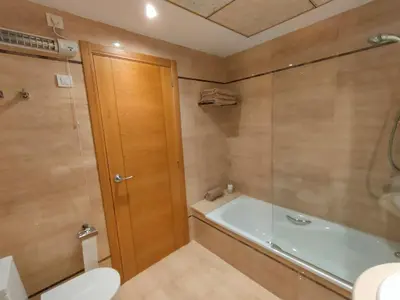 a bathroom with a tub and a toilet and a shower at NON STRESS Arena Primera línea de Playa in Valencia