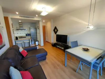 a living room with a couch and a table at NON STRESS Arena Primera línea de Playa in Valencia