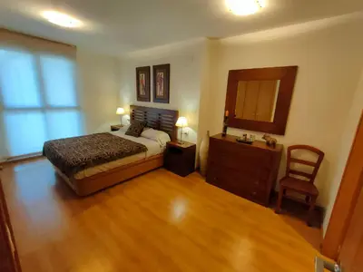 a bedroom with a bed and a dresser and a chair at NON STRESS Arena Primera línea de Playa in Valencia