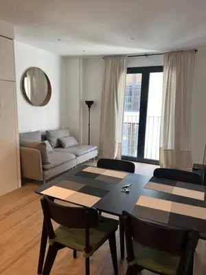a living room with a table and a couch at Apartamentos Mercado Central in Valencia