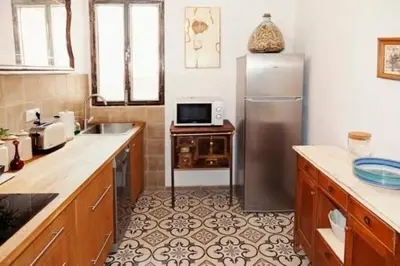 a kitchen with a stainless steel refrigerator and a microwave at Apartamento a 400m de la playa, Puerto de Sagunto in Puerto de Sagunto