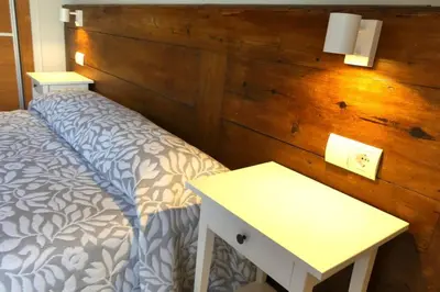 a bedroom with a bed and a white table at Ca Buganvilla. El corazón de la huerta valenciana in Meliana