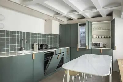 a kitchen with green cabinets and a white table at APARTAMENTO CENTRO DE VALENCIA PRECIOSA TERRAZA in Valencia