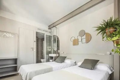 two beds in a room with white walls at APARTAMENTO CENTRO DE VALENCIA PRECIOSA TERRAZA in Valencia
