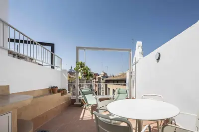 a balcony with tables and chairs on a building at APARTAMENTO CENTRO DE VALENCIA PRECIOSA TERRAZA in Valencia