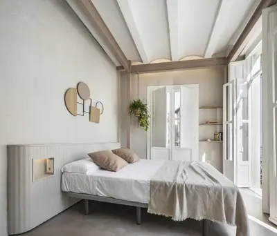 a bedroom with a bed in a white room at APARTAMENTO CENTRO DE VALENCIA PRECIOSA TERRAZA in Valencia