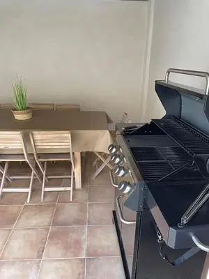 a kitchen with a grill and a table and chairs at UIM Mediterraneo Columbretes 1 Wifi in Puerto de Sagunto