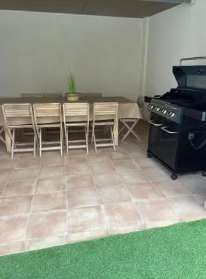 a kitchen with a table and chairs and a stove at UIM Mediterraneo Columbretes 1 Wifi in Puerto de Sagunto