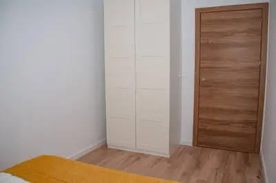 a bedroom with a closet and a wooden door at Soraya's Place - Chopín 1 in Valencia