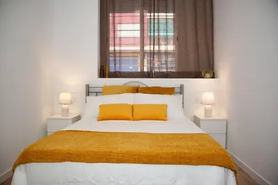 a bedroom with a large bed with yellow pillows at Soraya's Place - Chopín 1 in Valencia