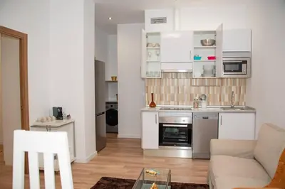 a kitchen and living room with a couch and a table at Soraya's Place - Chopín 1 in Valencia