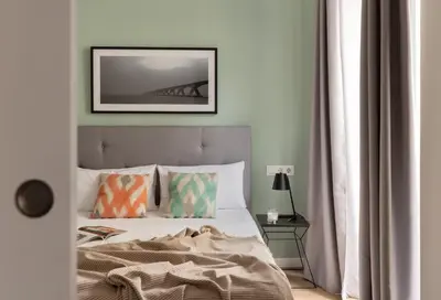 a bedroom with a bed and a picture on the wall at Líbere Valencia Jardín Botánico in Valencia