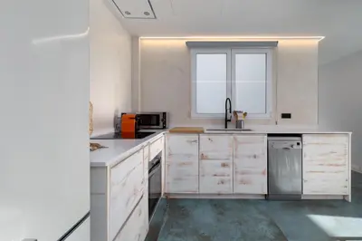 a kitchen with white cabinets and a window at Your home at Valencia, Marina Real in Valencia