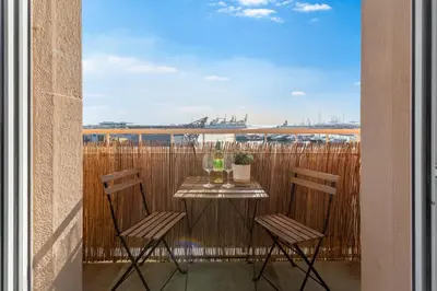 a table and chairs on a balcony with a view at Your home at Valencia, Marina Real in Valencia