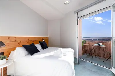 two white beds in a room with a balcony at Your home at Valencia, Marina Real in Valencia